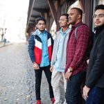 Group of four indian teen male students. Classmates spend time together.