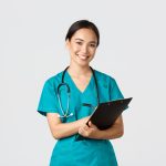 Healthcare workers, preventing virus, quarantine campaign concept. Cheerful friendly asian female physician, doctor with clipboard during daily checkup, standing white background.